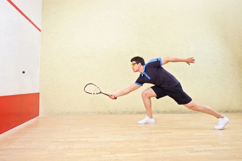 man plays squash