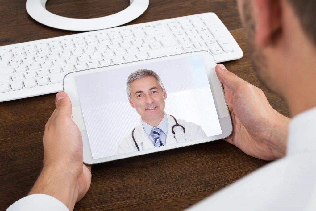 A man is chatting online with a doctor